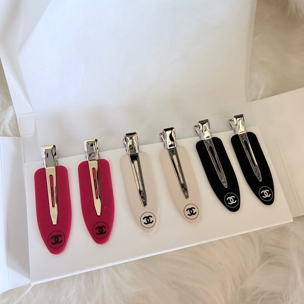 CHANEL Elegant Pink, White, and Black Hair Clips